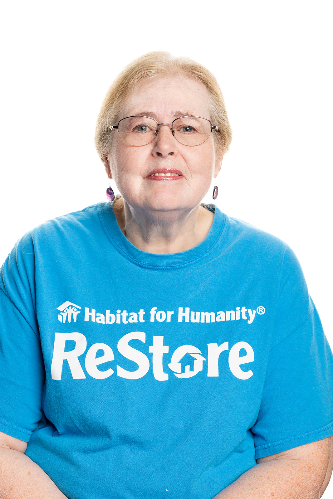 Staff in teal colored ReStore t-shirt