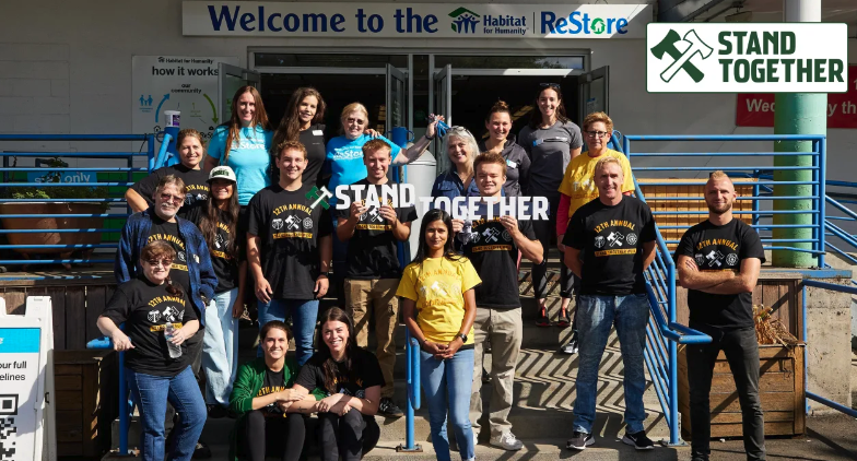 Picture of several Portland Thorns FC and the Portland Timbers FC volunteers in front of Portland ReStore