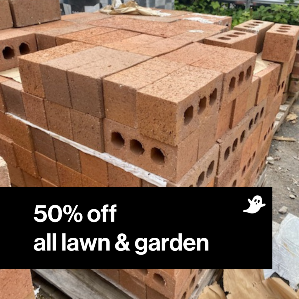 Stack of red bricks with 50% off all lawn & garden in black box.