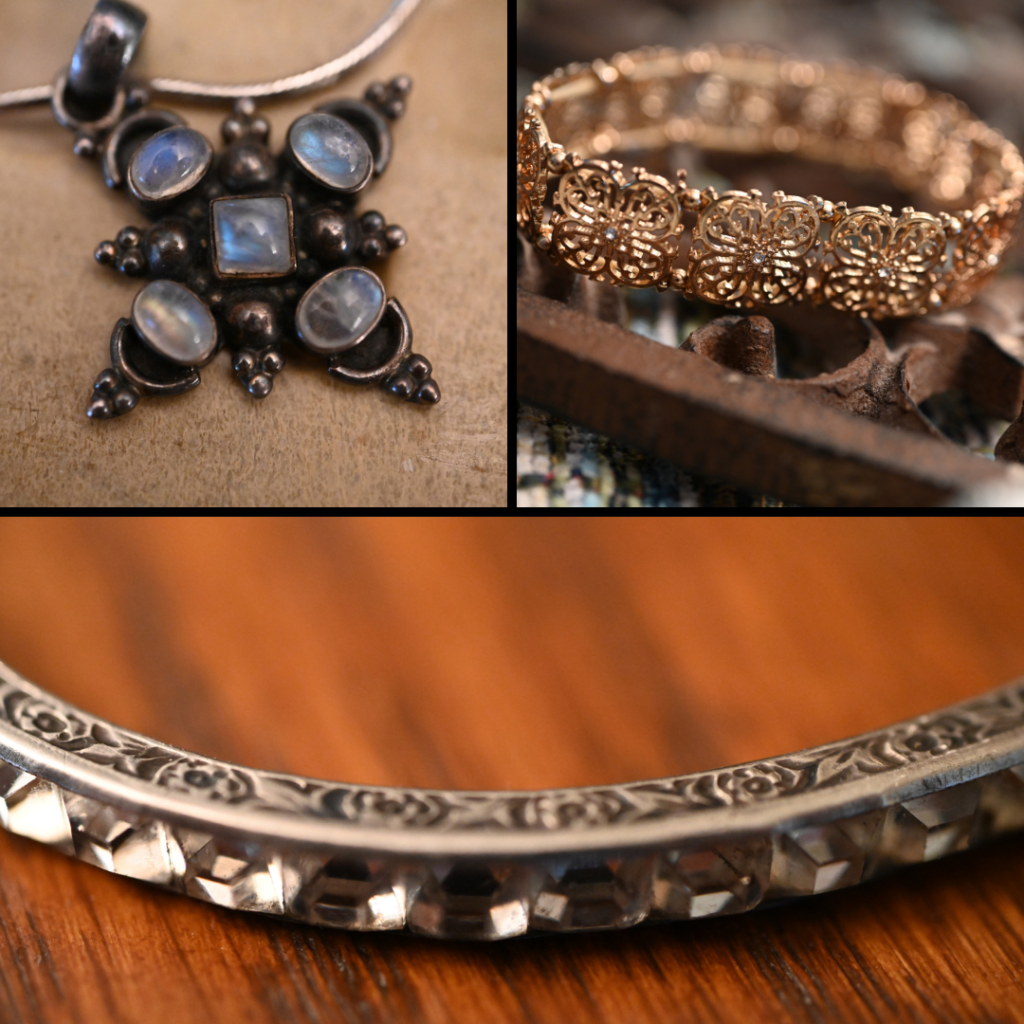 3 Vintage pieces including a pendant with opal like stones on black metal ornate back with silver chain; a gold flowers bracelet and silver ornate necklace.
